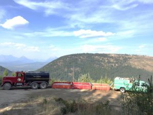 Cyclone Like Fire, Aug 2017 - Martin City water tender filling port-a-tanks, with Forest Service engine pumping water into hoses along the fire perimeter